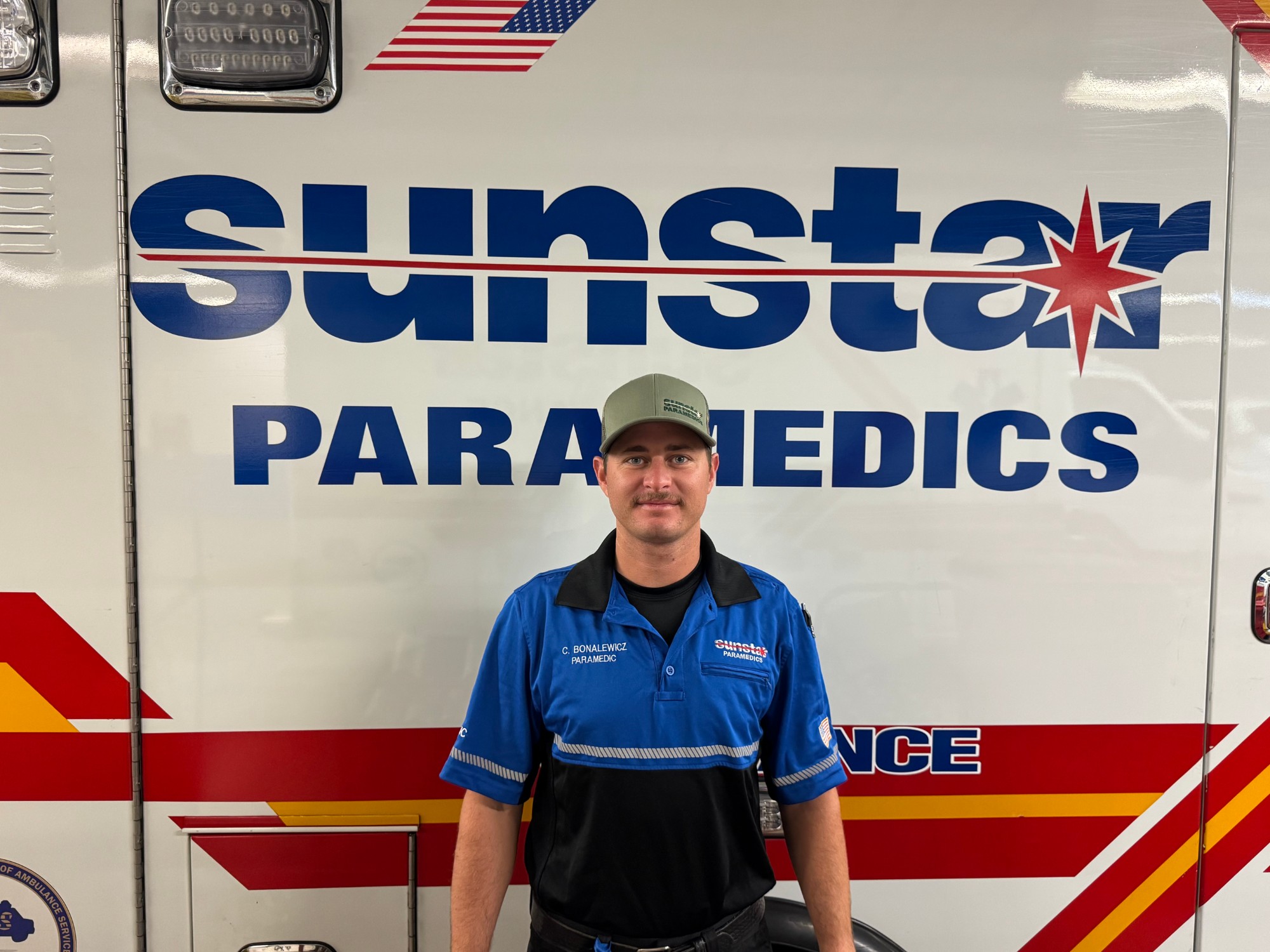Cody Bonalewicz as a field paramedic in front of an ambulance